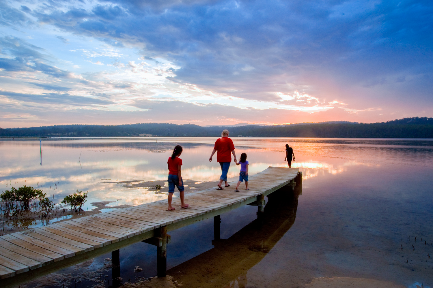 People walking on the Merimbula boardwalk